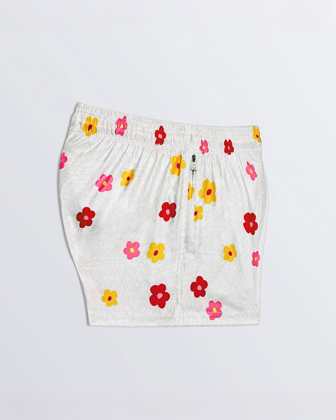 BUY MYSELF FLOWERS Poolside Shorts – side view showing vibrant print and sleek zip detail.