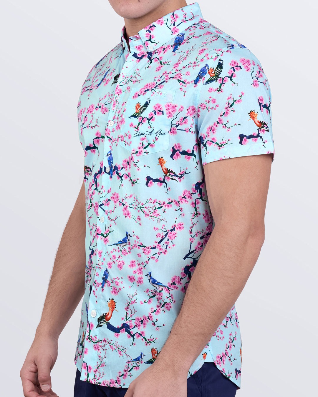 Men’s Close to You shirt featuring pink cherry blossoms and tropical birds on soft aqua cotton with tapered fit.
