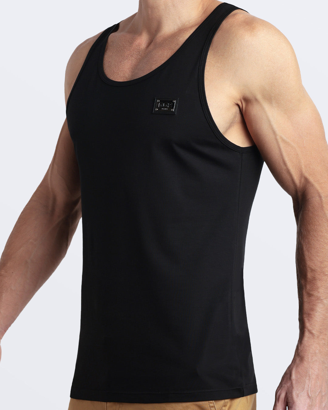 Side view of men’s workout tank top in EXACT BLACK a deep black color with a metallic plaque logo made by DC2 Clothing the new official brand of mens beachwear.
