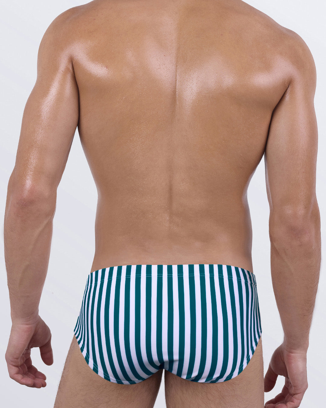 Back view of FAST LINES (PACIFIC GREEN) men’s swim sunga highlighting the snug mid-length waist coverage and sleek fit. Clean design and body-contouring stripes that emphasize movement and form.
