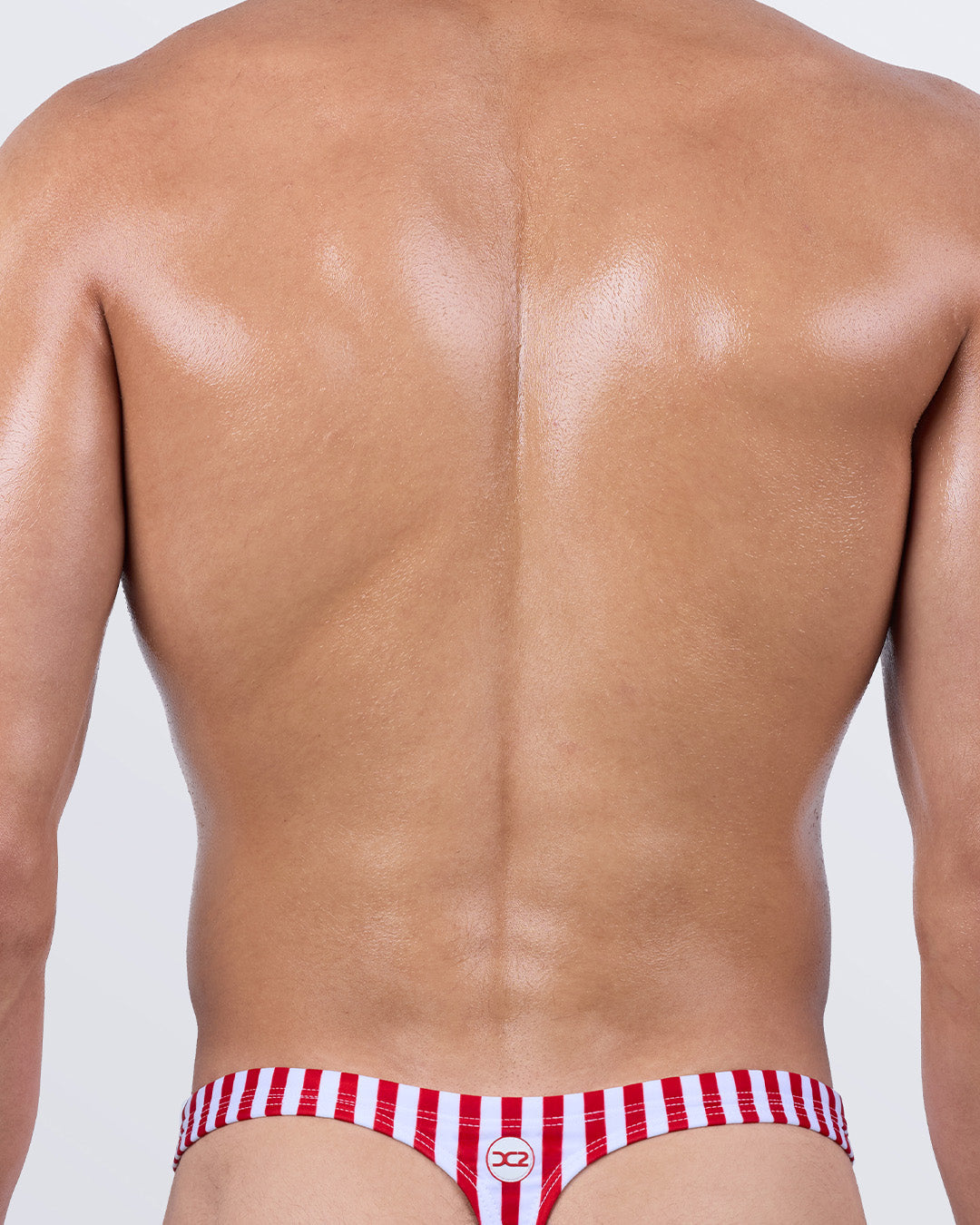 Back view of the FAST LINES (RAPID RED) men’s swim thong – classic T-back thong cut in red and white stripes, perfect for achieving minimal tan lines and a sleek fit.