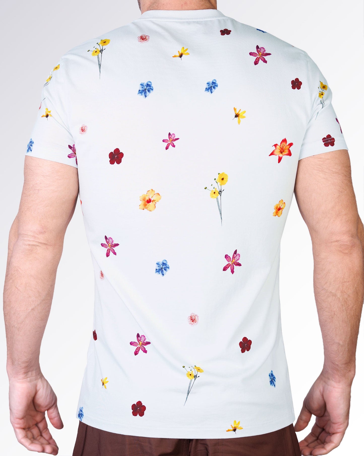 Back view of the Flower Powers Cream Graphic T-Shirt by DC2 Miami featuring an all-over floral pattern with vibrant flowers scattered across a cream base.