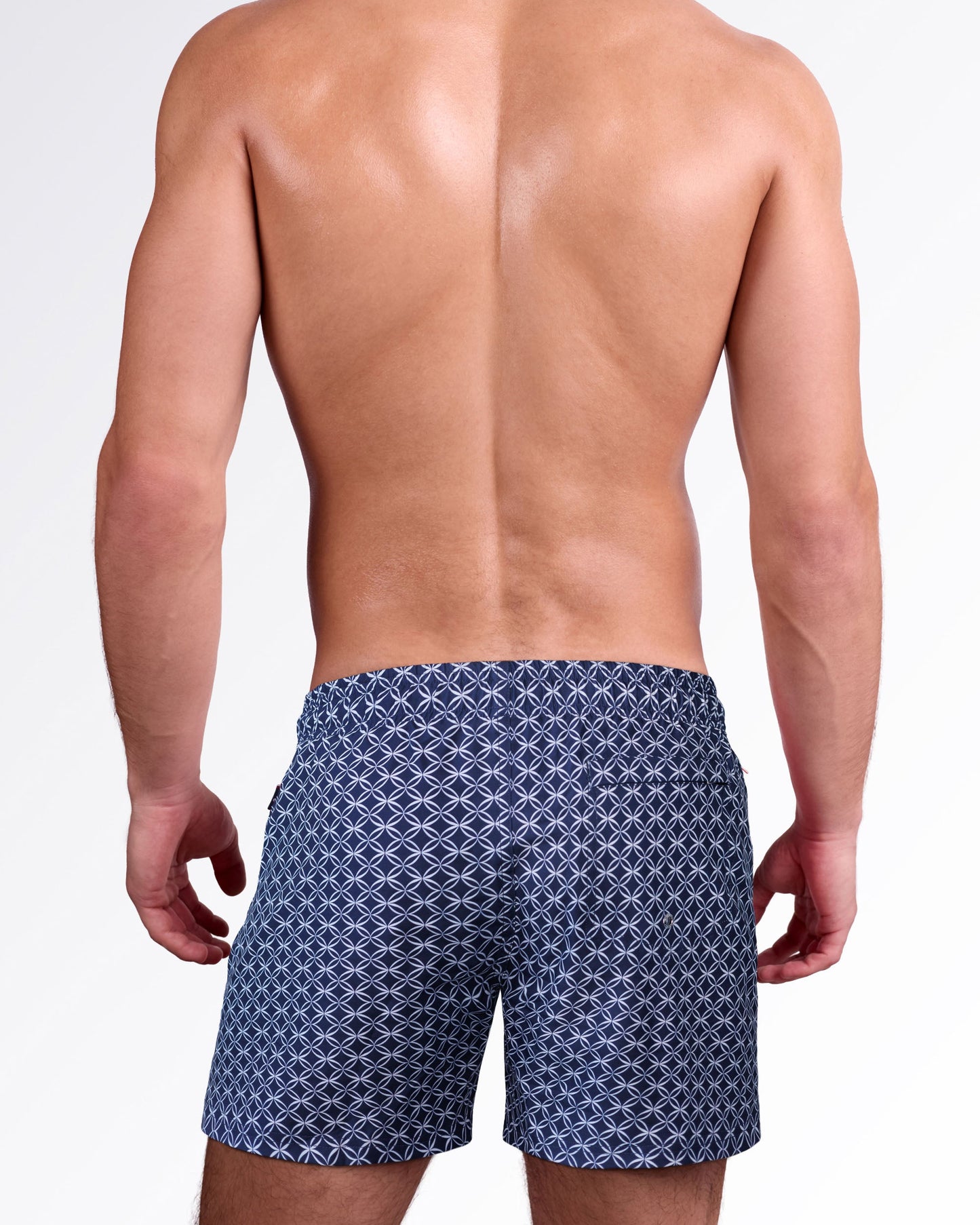 Back view of Mono Waves Blue Resort Shorts showcasing the navy geometric wave print, rear pocket, and relaxed resort swim fit.