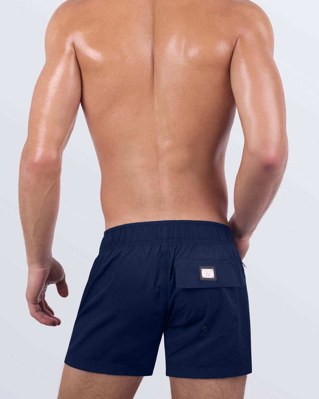 Back view of the NAVY BOOMER - Flex Shorts, showcasing the secure back pocket with a signature logo patch, along with an elasticated waistband for enhanced comfort.