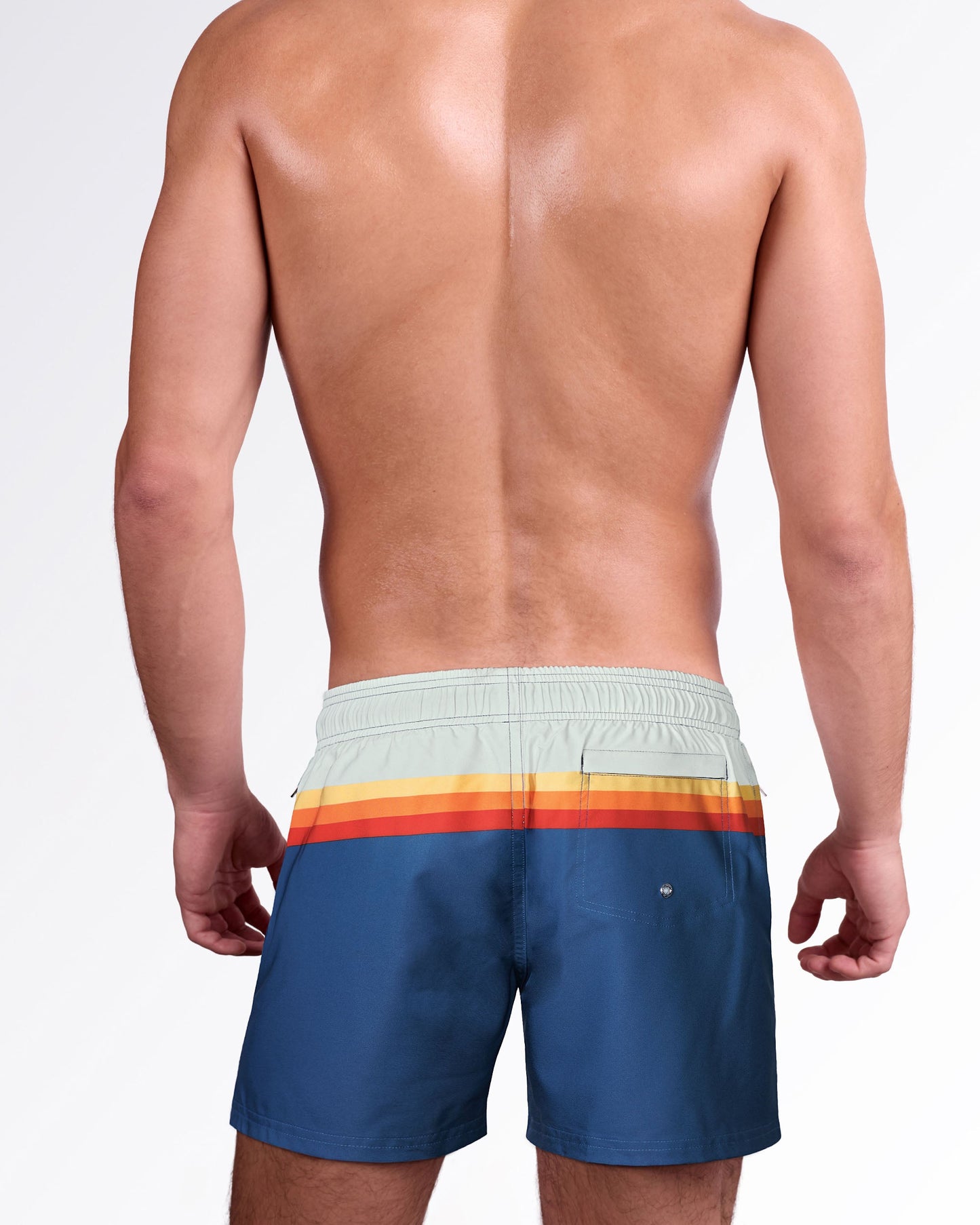 Back view of Sunset Stripes Resort Shorts showcasing the signature retro stripe detail, rear pocket, and relaxed resort swim silhouette.