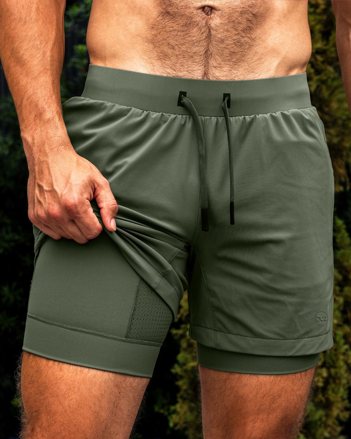DC2 Tactical Green Endurance Shorts — olive green 2-in-1 performance shorts with built-in compression liner and mesh panel detailing.