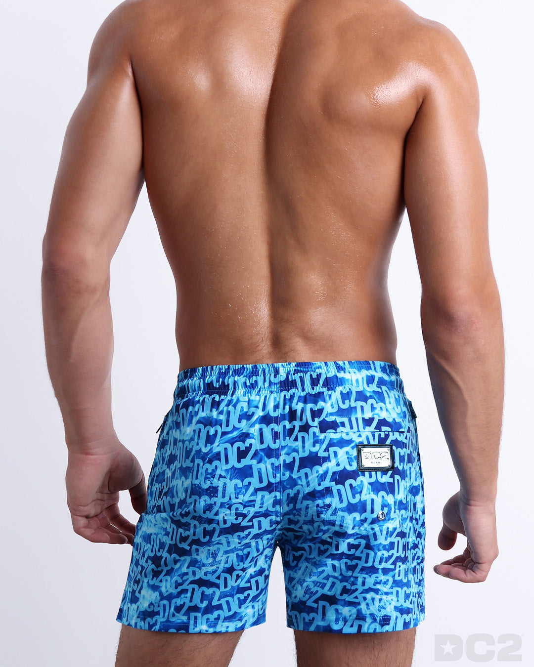 Back view of the WET beach Resort Shorts featuring a monogram print of the DC2 logo print, complete with a back pocket, designed by DC2.