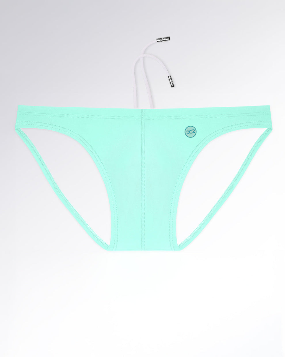 Model wearing AQUA LITE swim mini briefs for men in a smooth, solid seafoam mint color. Sleek and modern men’s swimwear with a minimal silhouette that celebrates clean lines and understated summer freshness.