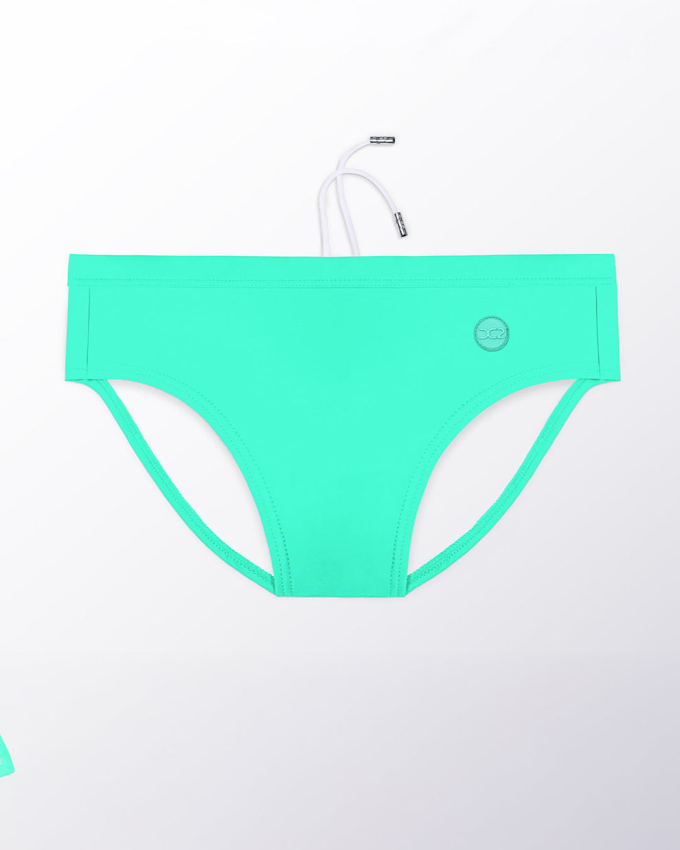 Flat lay of the DC2 Aqua Glow Swim Brief, featuring a luminous aqua tone and sleek, sculpted swim brief design.