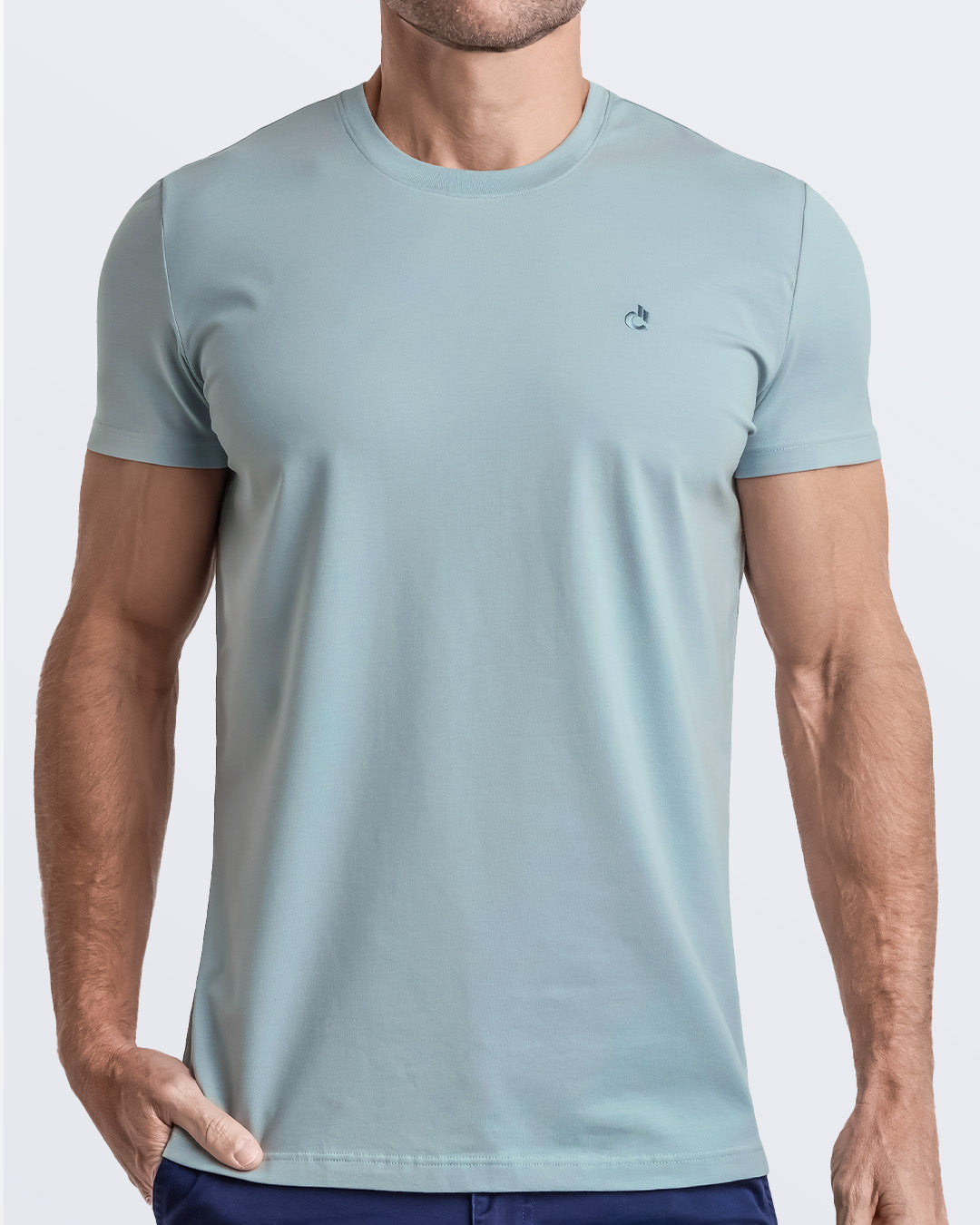 Frontal view of a male model wearing a light teal color modal cotton t-shirt, crafted for stylish casual wear and beachwear by DC2 Miami. Premium quality men's streetwear t-shirt, perfect fit for summer fashion.