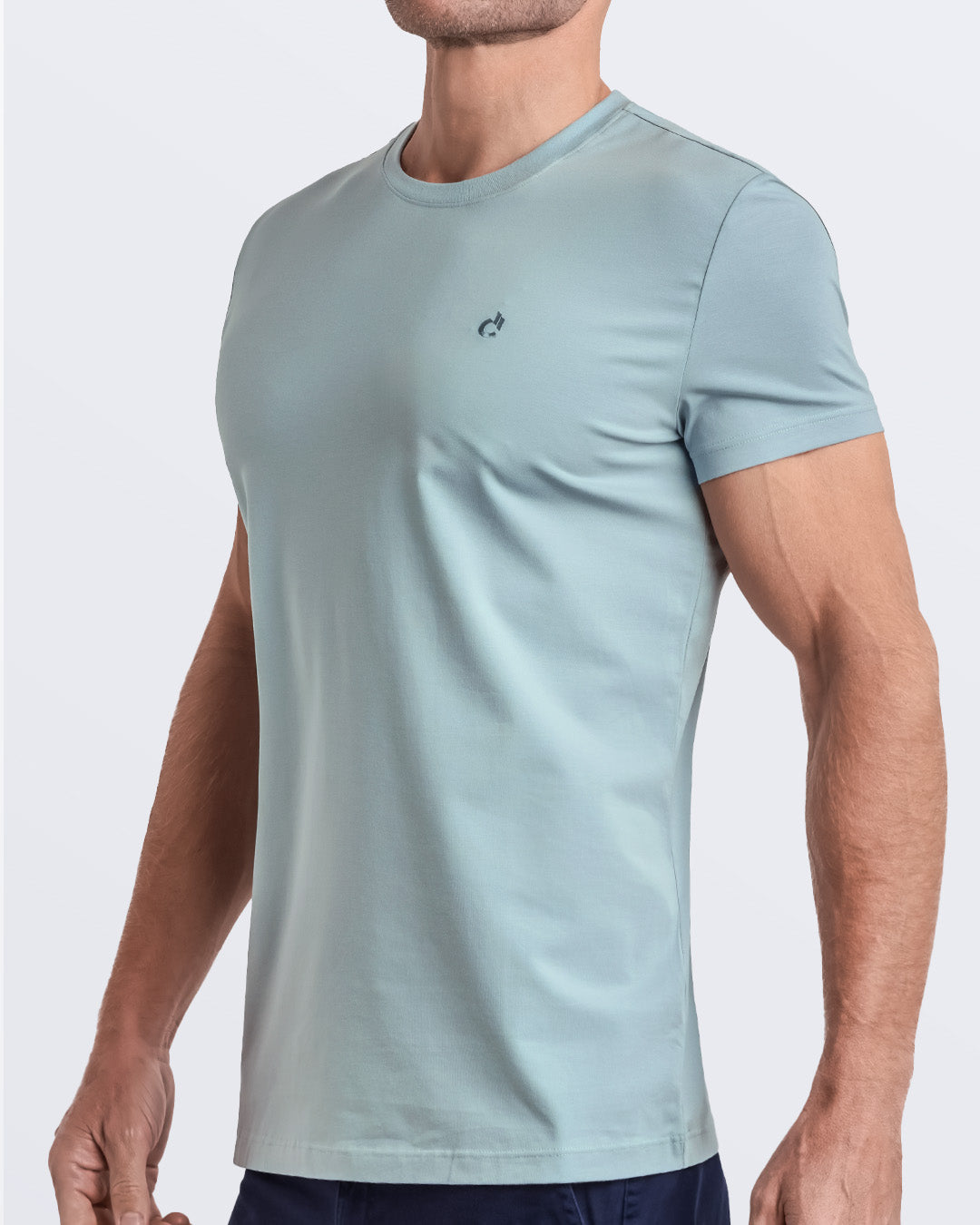 Side view of a men's premium light teal modal cotton t-shirt and embroidered DC2 logo. Perfect for a modern casual look, this streetwear tee is part of the DC2 Miami men's beachwear collection, designed for comfort and style.