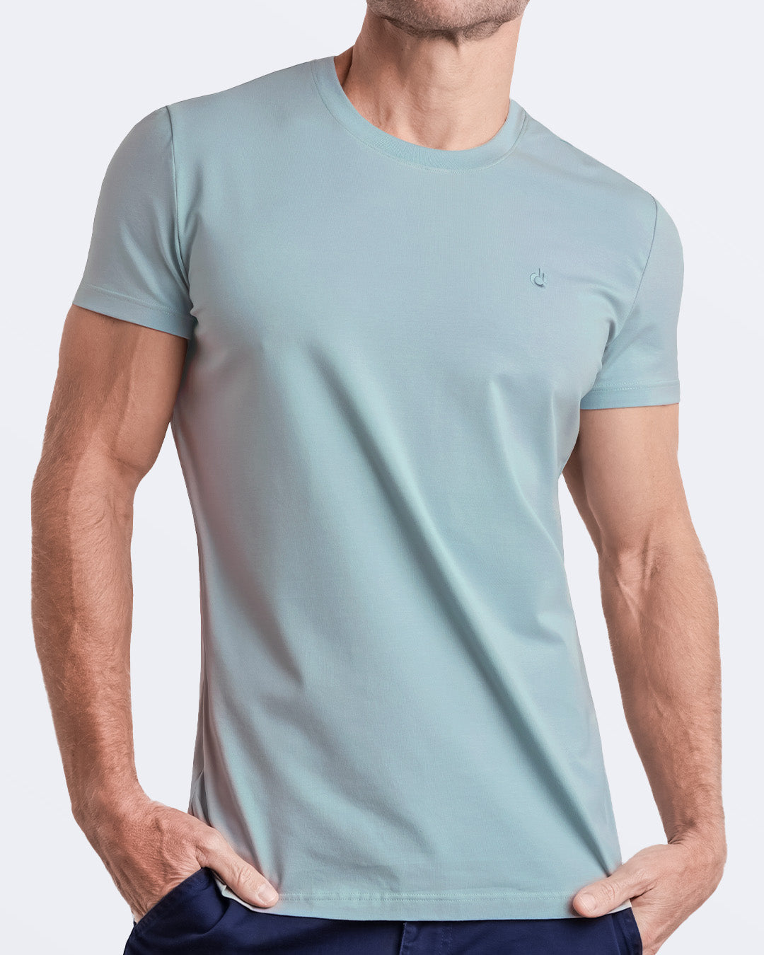 Frontal view of a male model wearing a light teal color modal cotton t-shirt, crafted for stylish casual wear and beachwear by DC2 Miami. Premium quality men's streetwear t-shirt, perfect fit for summer fashion.