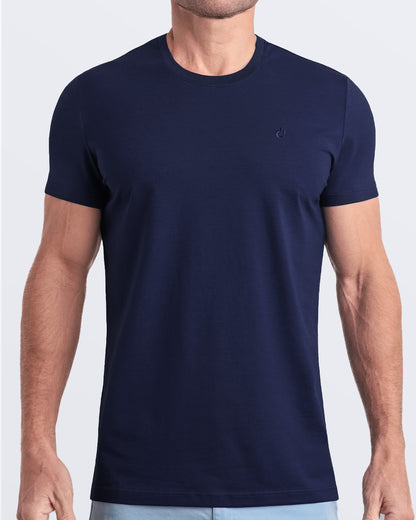 Frontal view of a male model wearing a navy blue modal cotton t-shirt, crafted for stylish casual wear and beachwear by DC2 Miami. Premium quality men's streetwear t-shirt, perfect fit for summer fashion.