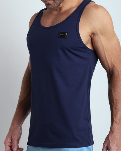 Side view of men’s workout tank top in BE MY NAVY a rich, deep navy blue color with a metallic plaque logo made by DC2 Clothing the new official brand of mens beachwear. 