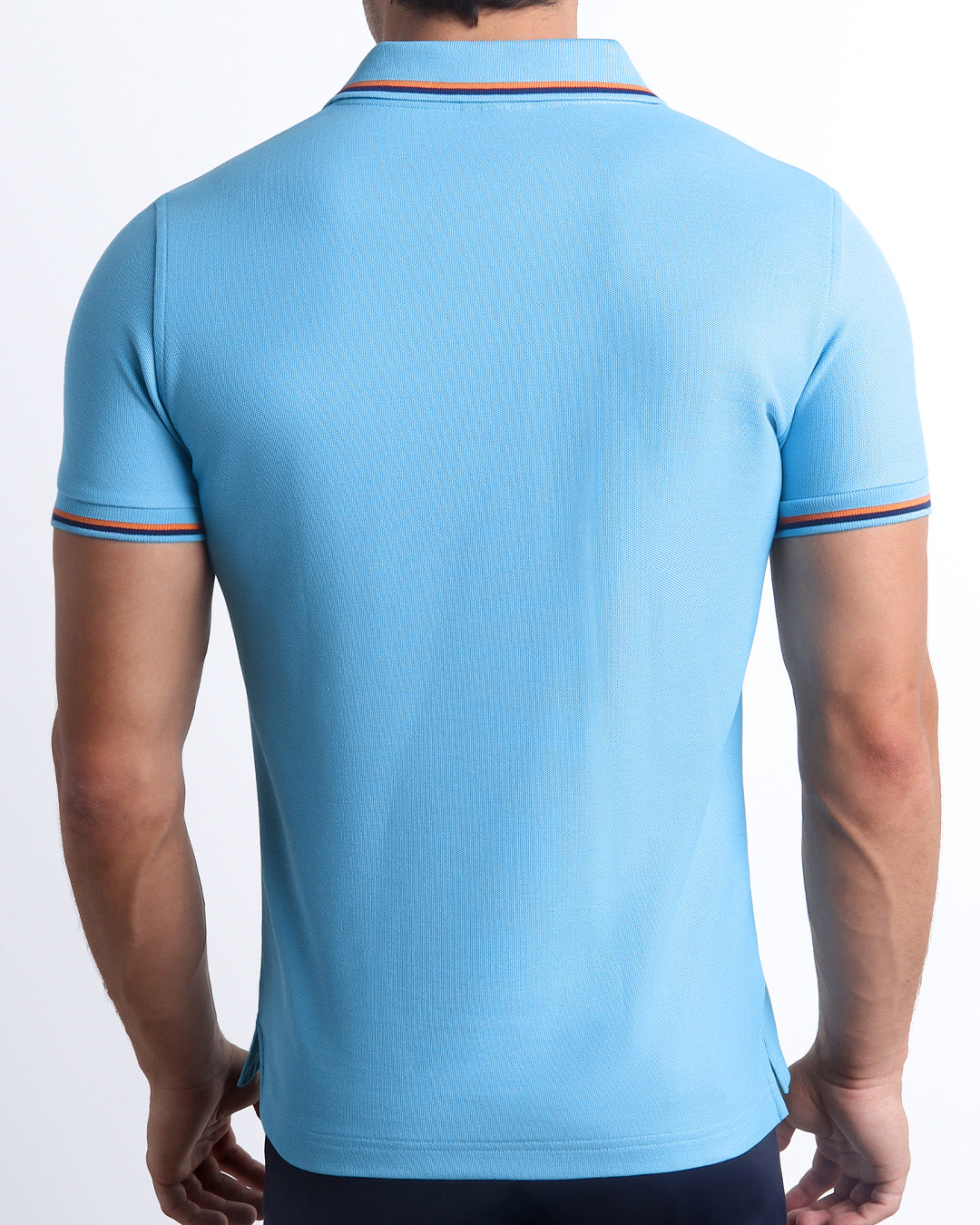 Back View of the BISCAYNE LIGHT BLUE Premium Cotton Polo Shirt for Men in solid light blue with orange and navy blue stripes on ribbed-knit collar and cuffs. The short-sleeve classic polo shirt is designed by DC2 in Miami.