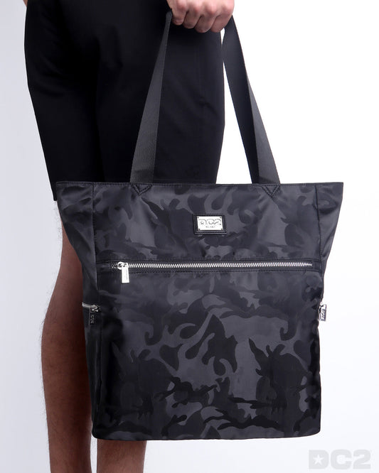 The BLACK CAMO Poolside Tote Bag in a black camoflauge print. This perfect day tripper bag protect your belongings from spills and splashes designed by DC2 in Miami.