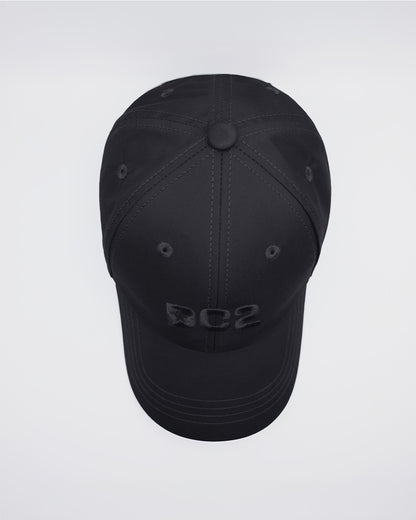 Overhead view of the BLACK Chillax Cap, highlighting the structured top panel with precise stitching and the subtle DC2 logo on the front. The cap is made from durable black fabric with a smooth finish, designed to offer both style and comfort.