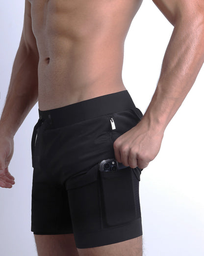 Side view of men’s triaining in a solid black color with interior compression phone pocket made made by DC2 the official brand of mens sportswear.