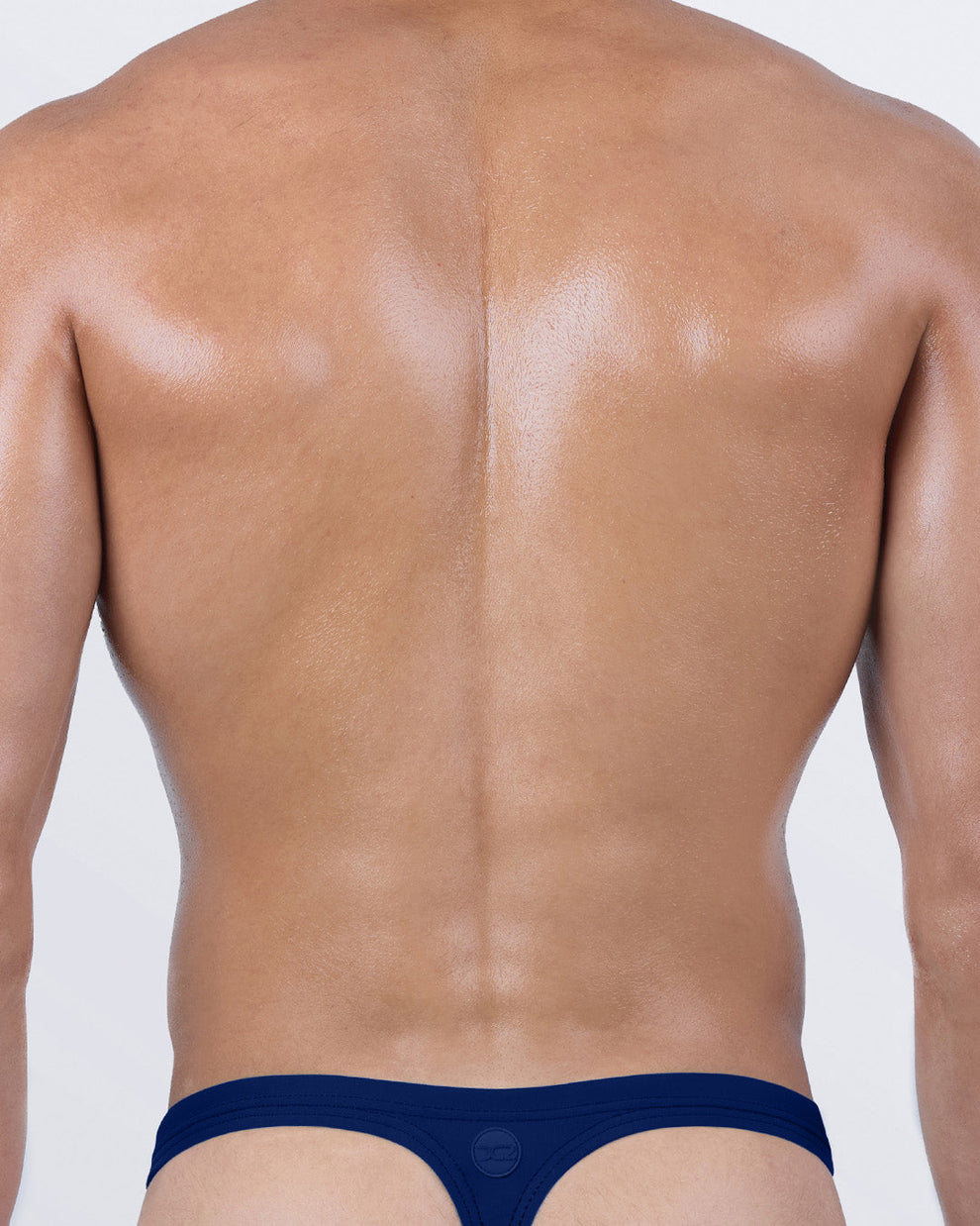 Back view of men’s BLUE BY THE OCEAN swim thong – T-back design for minimal coverage and bold style – by DC2 BANG! Clothing.