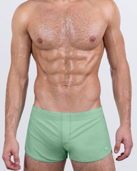 DC2 CABANA GREEN — model wearing Cabana Green Swim Shorts, featuring a soft matte green tone and low-rise retro fit.
