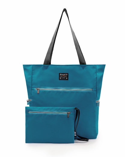 Front view of the CHIC TEAL Poolside Tote Bag by DC2 Miami, featuring a sleek solid teal color. The tote is spacious with durable black handles and multiple zippered compartments, including a detachable pouch with a matching color. Made from high-quality, water-resistant material, this versatile tote bag is perfect for beach outings or casual everyday use.