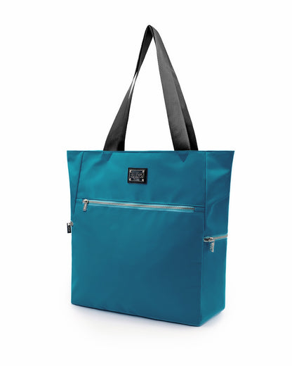 The CHIC TEAL Poolside Tote Bag by DC2 Miami, features a solid teal color. This bag is a perfect companion for beach outings, shopping trips, or everyday use.