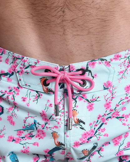 Close-up view of men’s summer Flex shorts by DC2 clothing brand, showing pink color cord with custom-branded metallic silver cord ends, and matching custom eyelet trims in black.