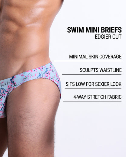 Infographic explaining the edgier cut of the Swim Mini Briefs. Features sculpt waitline, 4-way stretch fabric, sits low for sexier look, and has quick-dry material.