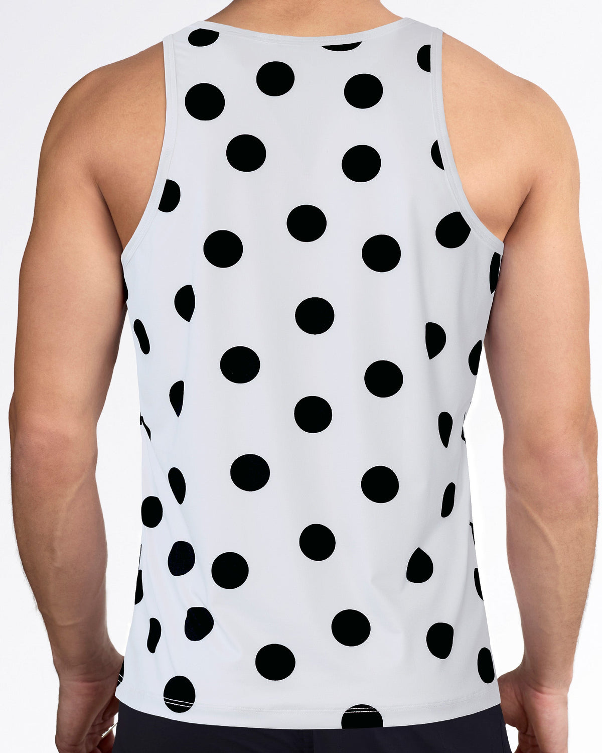 Men’s workout tank top with racerback-style cut, allover black dot print, white performance fabric, and sleeveless fit.