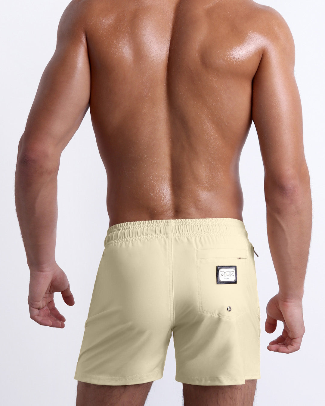 Back view of the CREAM FIELDS beach Resort Shorts in a solid light yellow color, complete with a back pocket, designed by DC2 a capsule brand by BANG! Clothes based in Miami.