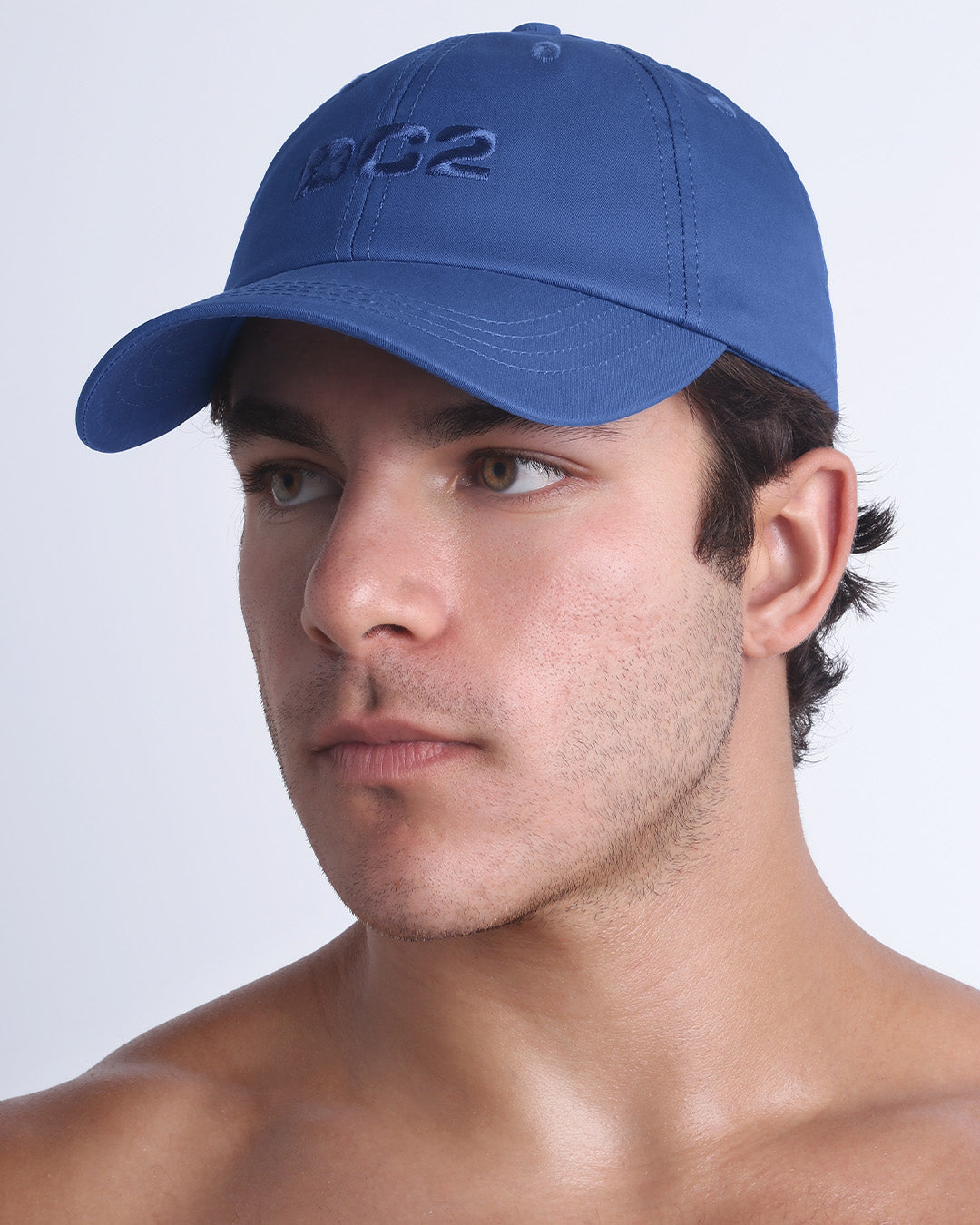 Side view of the Chillax Cap in DENIM BLUE,  a dark blue color, features ventilation eyelets on the cap to provide extra breathability, perfect for active wear.