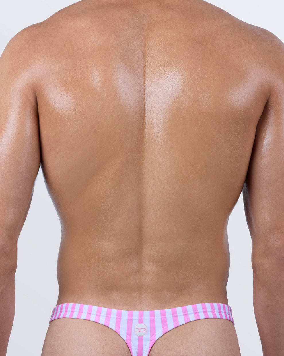 Back view of DC2 FAST LINES (CHILL PINK) men’s swim thong featuring minimal coverage and signature 'T' back.