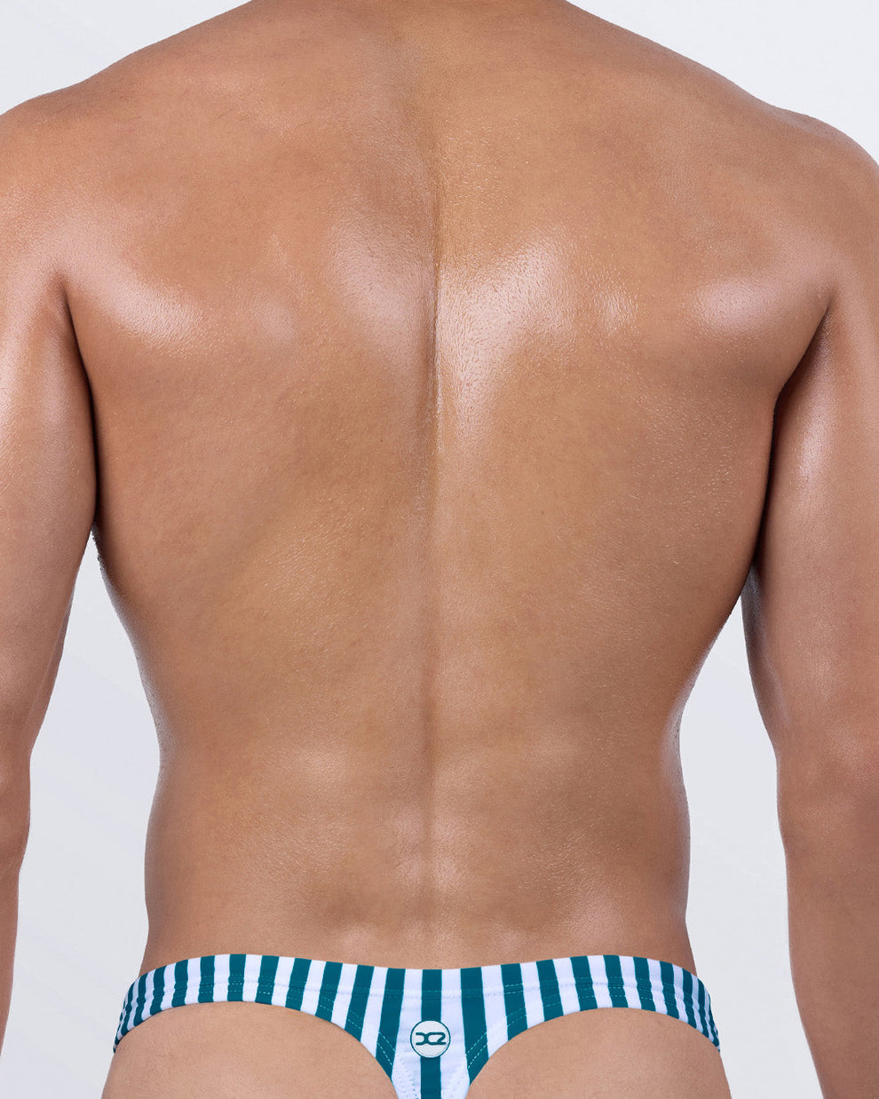 Back view of FAST LINES (PACIFIC GREEN) thong swimwear for men – T-back cut in green and white stripes by DC2 BANG! Miami, perfect for showing off and tanning.