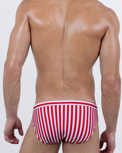 Back view of DC2 FAST LINES (RAPID RED) swim brief showing red and white striped design, snug fit, and contour seam on men's swimwear.
