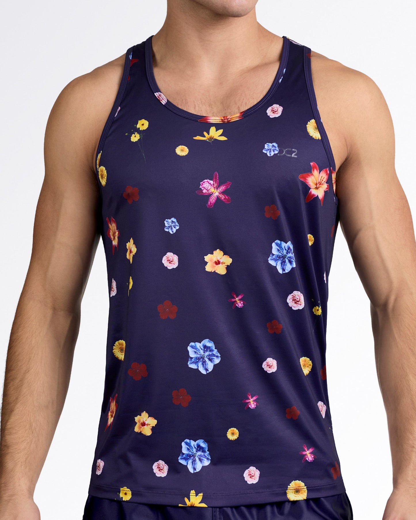 DC2 Flower Powers (Blue) Gym Tank Top — model wearing navy floral men’s tank featuring multicolor flower print on smooth performance fabric.