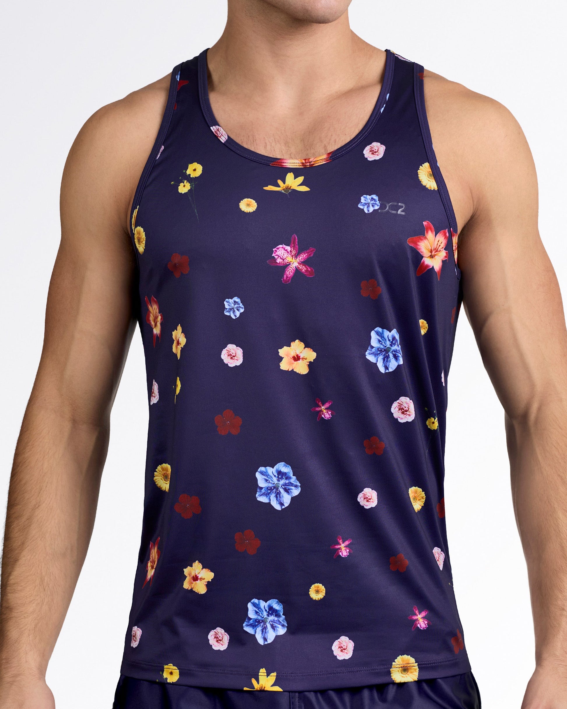 DC2 Flower Powers (Blue) Gym Tank Top — model wearing navy floral men’s tank featuring multicolor flower print on smooth performance fabric.