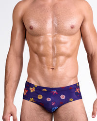 DC2 Flower Powers Blue Swim Brief — front view featuring deep blue base with multicolor floral print, low-rise tailored fit and smooth waistband finish.