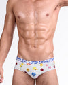BANG! Flower Powers (Cream) Swim Brief — front view featuring multicolor floral print on cream base with contrasting blue floral waistband and low-rise tailored fit.