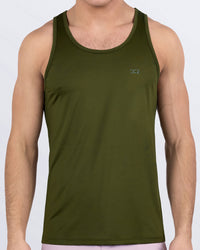 Male model wearing DC2 Miami GREENSPIRATION gym tank top in deep olive green color, featuring a minimalist design and breathable performance fabric