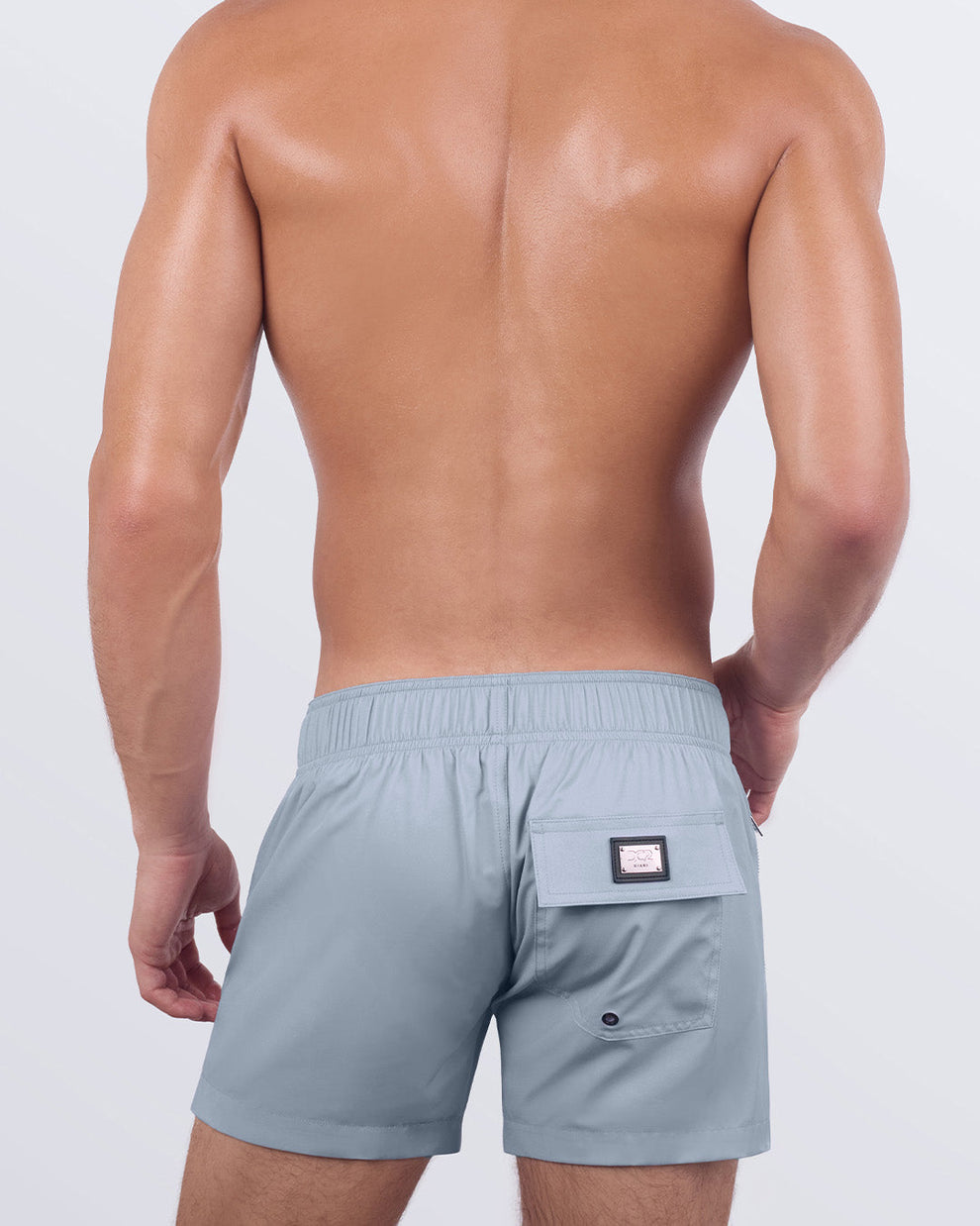 A back view of the GREY ANATOMY - Flex Shorts, highlighting the elasticated back waistband, secure flap pocket, and signature logo detail, offering both style and function.