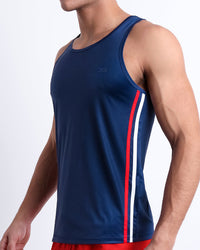 DC2 Imperial Blue Gym Tank Top on model — side view highlighting red and white athletic side stripes and lightweight performance fabric.