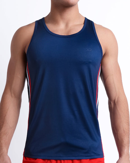 DC2 Imperial Blue Gym Tank Top — front view showing sleek fit, moisture-wicking fabric, and red and white striped side accents.