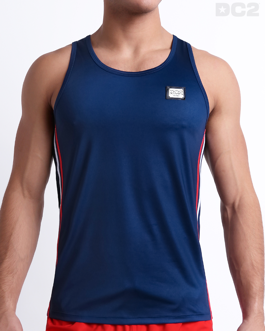 Male model wearing IMPERIAL BLUE men’s casual Tank Top. A premium quality top in a solid navy color with red and white stripes on the sides, a men’s beachwear brand from Miami.