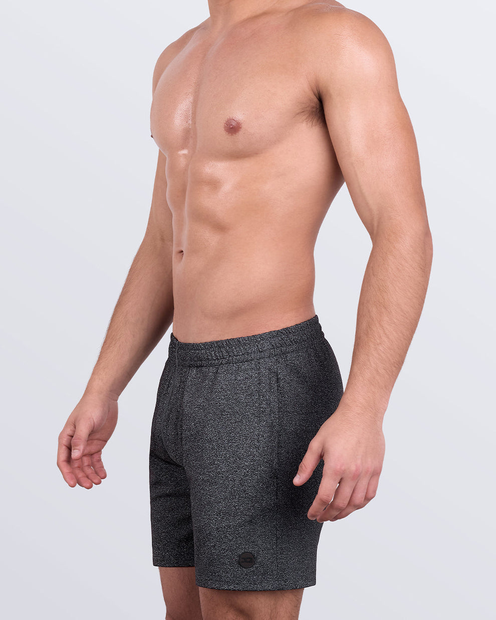 DC2 IRON BLACK Jogger Shorts — side profile with model’s hand down, showcasing tapered cut and side pocket placement.