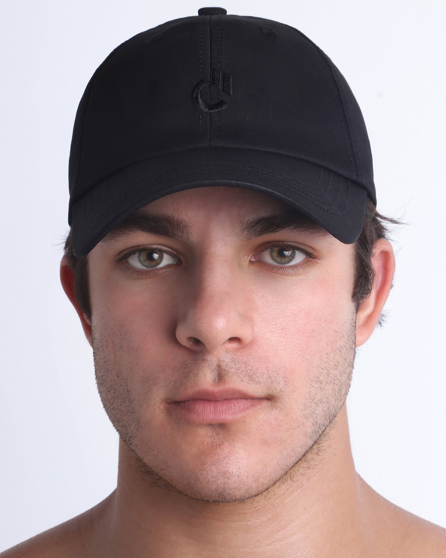 DC2 Resort Cap in black worn by model, minimalist structured baseball cap with tonal embroidered logo.