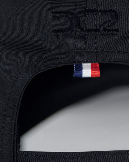 Interior detail of DC2 White Resort Cap — soft cotton lining, adjustable strap, and branded care label.
