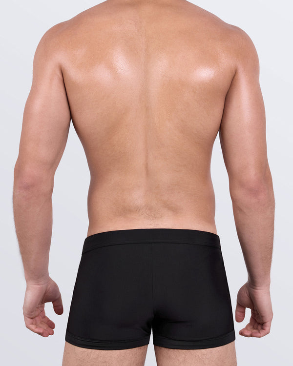 DC2 JET BLACK Swim Trunks — back view showing form-flattering silhouette with smooth waistband and contoured cut.