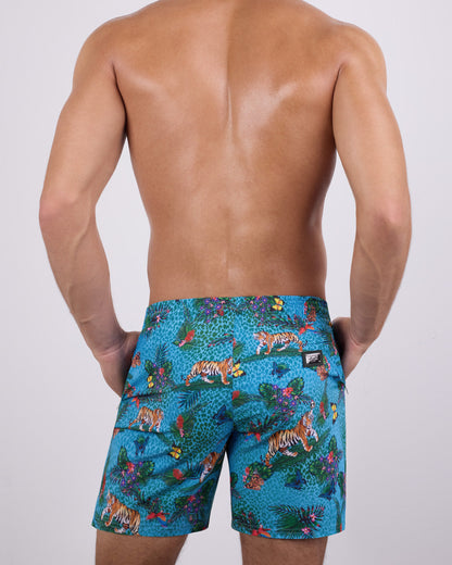 Back view of a male model wearing the JUNGLE BOOGIE Resort Shorts by DC2 Miami. These resort-style swim shorts showcase a tailored, long-leg cut, a functional back pocket with a DC2 signature metal logo plaque, and a breathable, quick-dry fabric for ultimate comfort.