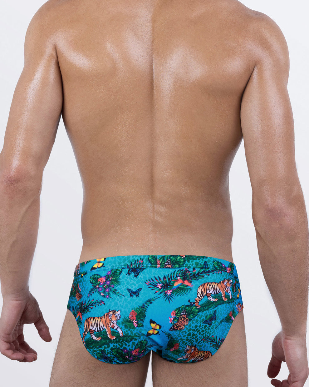 Back view of Jungle Boogie men’s designer swim briefs by DC2 – vibrant tiger and butterfly pattern on teal jungle backdrop – supportive and flattering rear coverage.