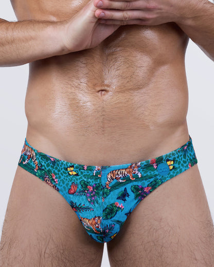 Close-up of tropical Jungle Boogie Swim Mini Briefs for men – luxury designer swimwear with animal and floral print, by DC2 BANG.